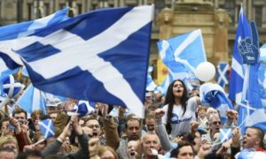 Campaigners wave Scottish Saltires at a 'Yes' campaign rally in Glasgow